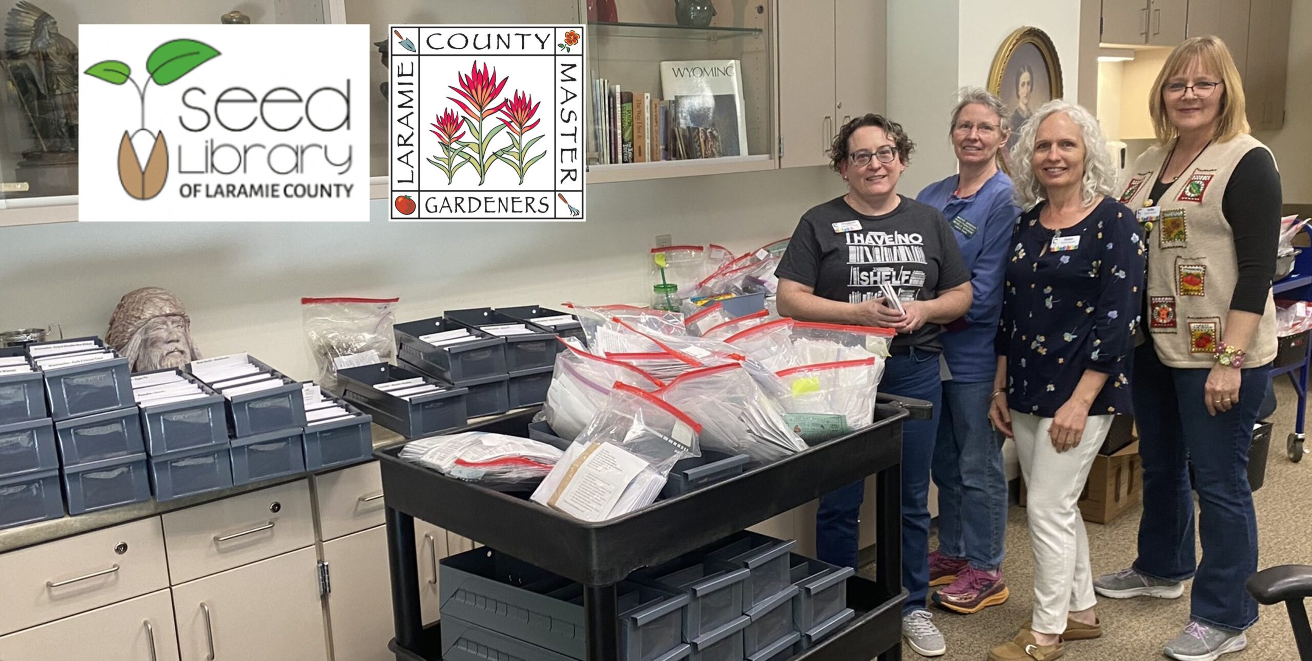 Laramie County Seed Library Co-Chairs & Volunteers standing next to Seed Library Supplies